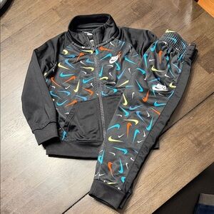 Nike Kids' Black Tracksuit with Vibrant Swooshes